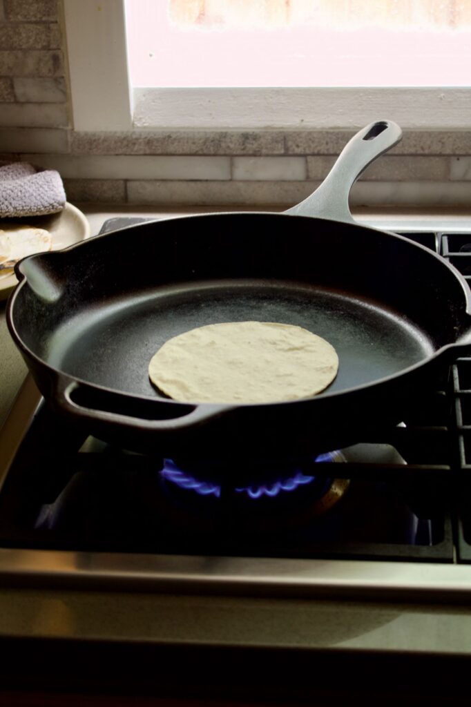 one corn tortilla on skillet