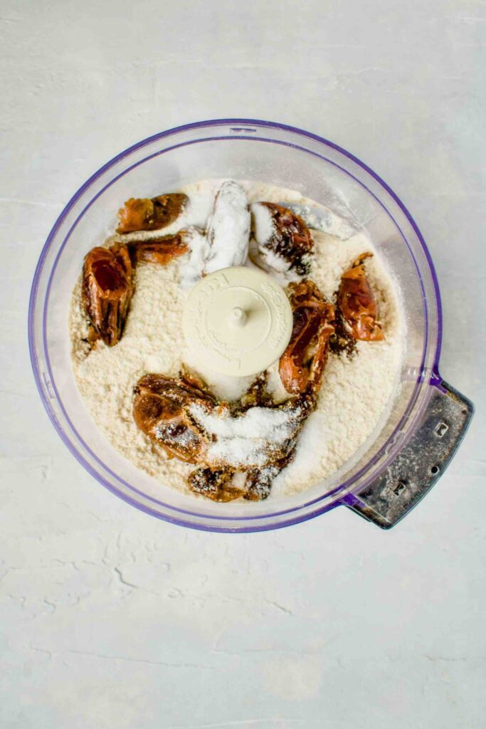 Prep. Heat your oven to 325 degrees Fahrenheit and line a rimmed baking sheet with parchment paper or line with a silicone mat. Hydrate ground flaxseeds. Place the ground flaxseeds into a bowl and cover with the water. Stir gently then set aside and let hydrate for about 5 minutes. Process dates and flour. In a food processor, blend the medjool dates and flour together. Process until they look like wet sand (about 45 - 60 seconds). Add in the salt and baking soda and pulse in with the dates and flour. Combine wet ingredients. In a large bowl, whisk melted butter, the hydrated flaxseeds, and vanilla together until everything is fully emulsified. Mix together. Add the processed ingredients from the food processor into the large bowl with the wet ingredients. Mix together until well combined. Fold in the chocolate chips. Bake. Scoop up ~2 tablespoons worth of dough and make into a ball. Arrange the dough balls on the cookie sheet, about 2” apart. Press each ball down slightly. Bake for 13 - 15 minutes. Enjoy! Let the cookies cool on the cookies sheet for about 10 minutes before transferring to a wire rack to cool fully. Enjoy your perfect eggless chocolate chip date cookies!