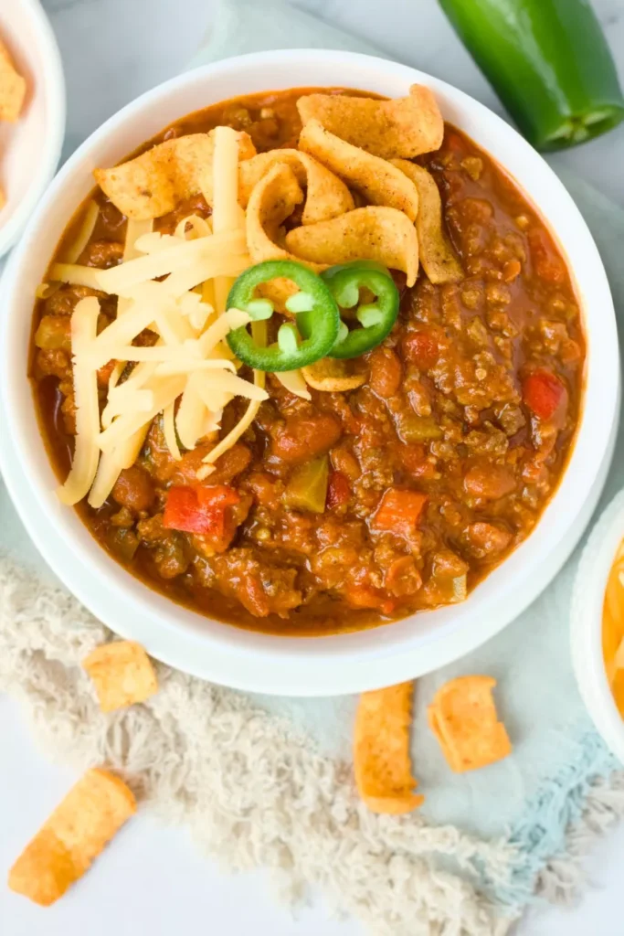Warm, hearty, and packed with ground beef, Italian sausage, beans, and veggies, this large batch meaty chili is perfect for feeding a crowd.